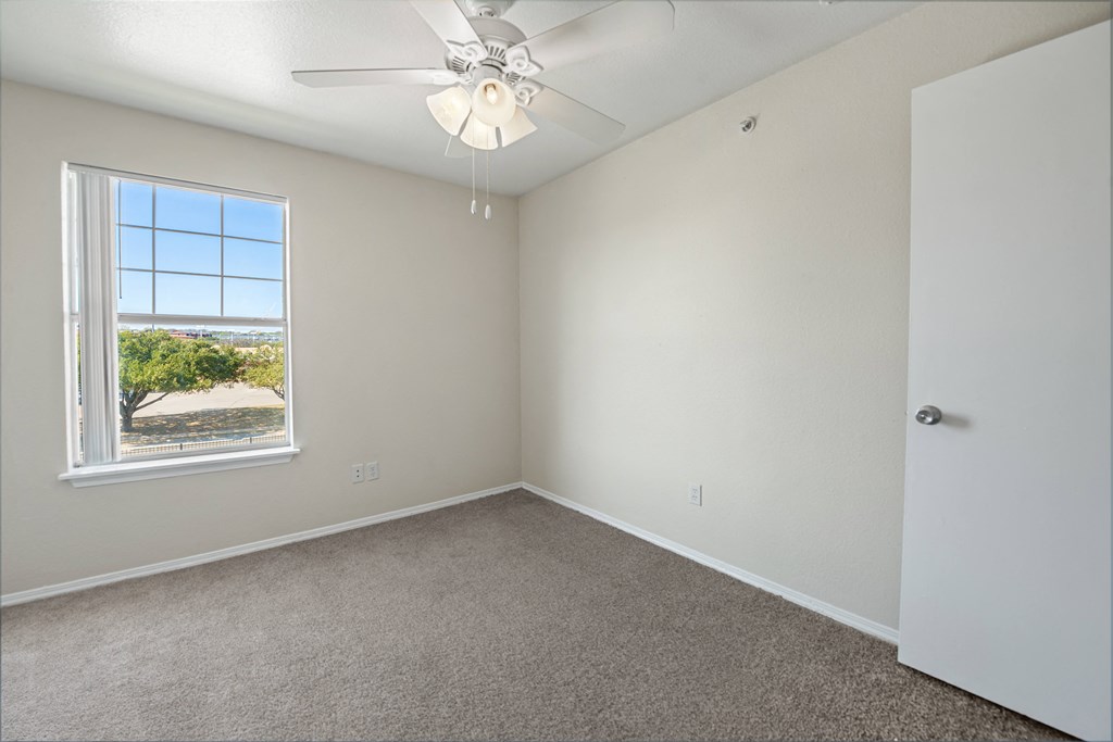 a bedroom with a ceiling fan and a window  at Collective on Riverside, Austin, 78741